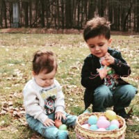 Two children play with easter eggs