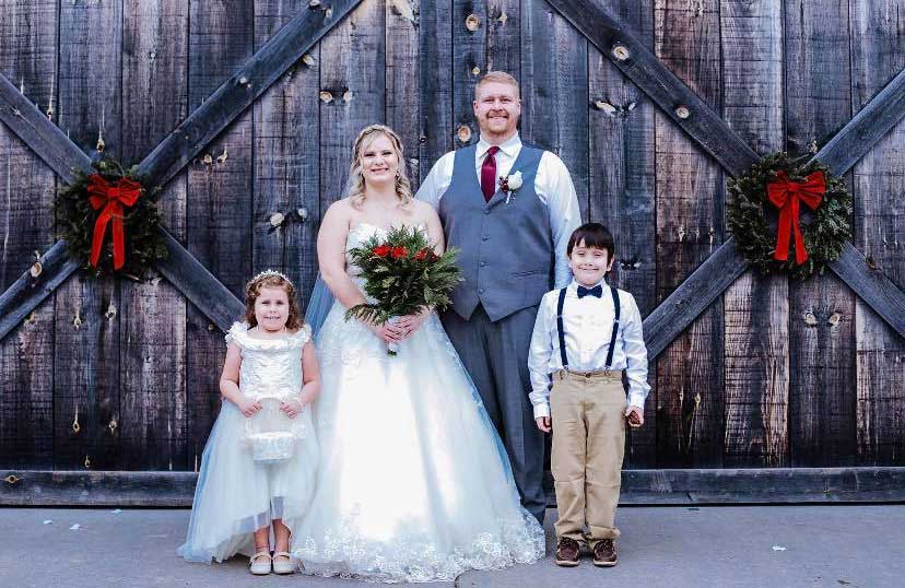 A bride, groom and two children